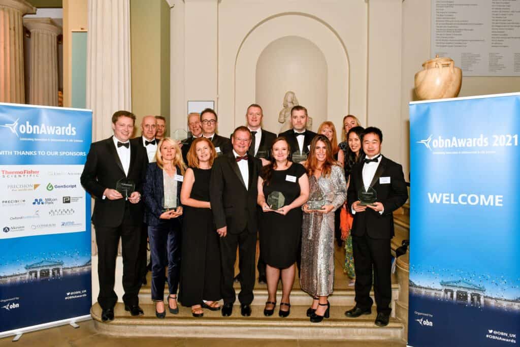 Group of people, winners at OBN awards night holding their trophies